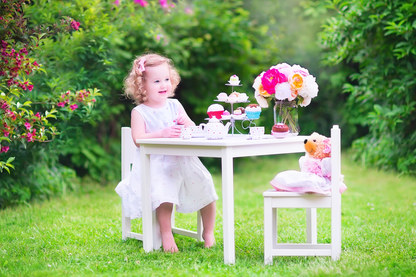 Young girl having a tea party with her teddy bear [Image © famveldman - Fotolia.com]