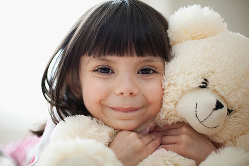 Child Hugging Teddy Bear [Image © Adobe Stock / Hero Images]